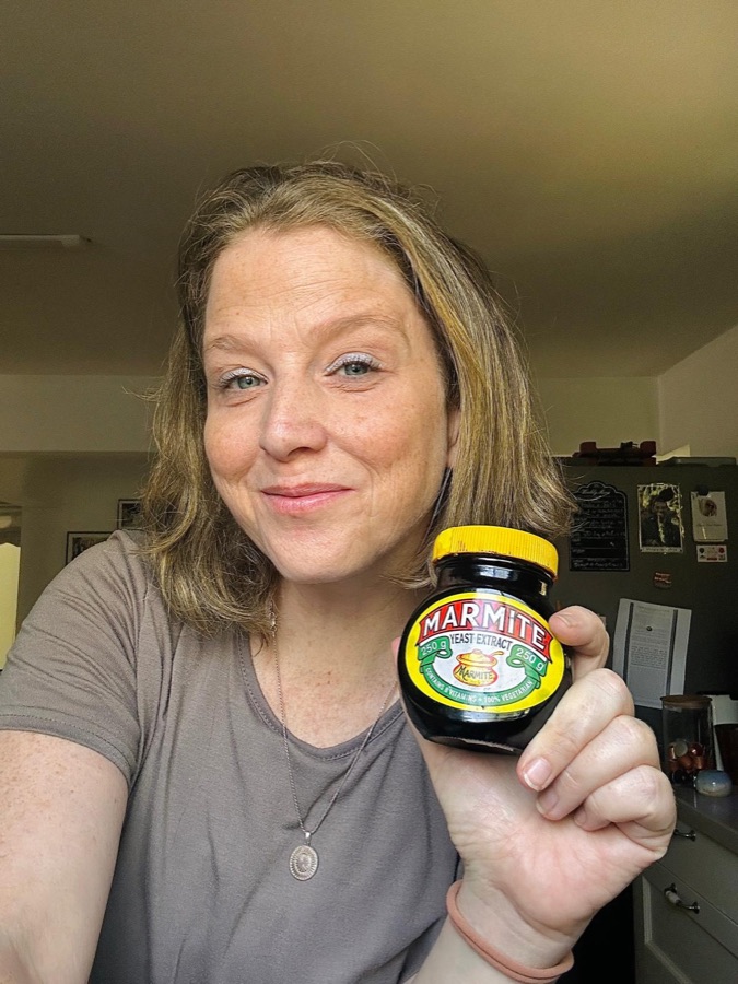 Sarah holding up a jar of Marmite